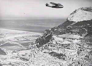 A Catalina flies by the North Front of the Rock as it leaves Gibraltar on a patrol (March 1942).jpg