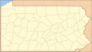 A map of the state of Pennsylvania with a red dot in the north-central part