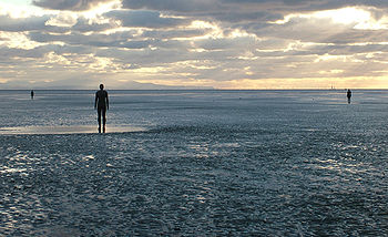 Sculpture "Another Place" by Antony Gormley.